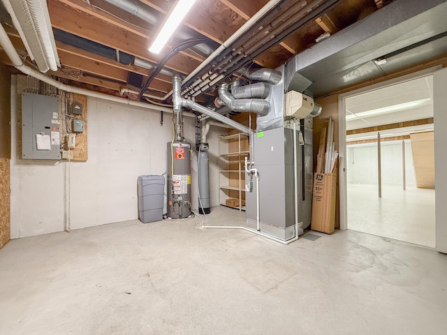 basement with electric panel, heating unit, and water heater