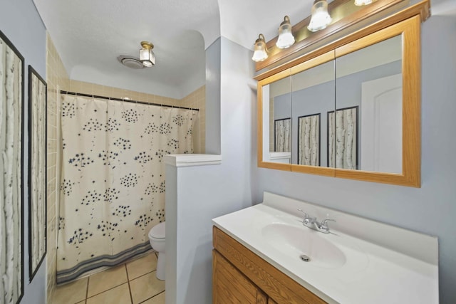 bathroom featuring a shower with shower curtain, vanity, toilet, and tile patterned floors