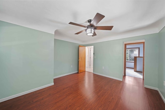 spare room featuring dark hardwood / wood-style flooring and ceiling fan