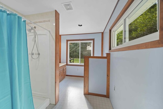 bathroom featuring crown molding, vanity, and curtained shower