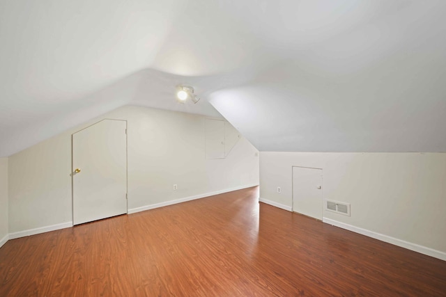 bonus room featuring vaulted ceiling and hardwood / wood-style floors