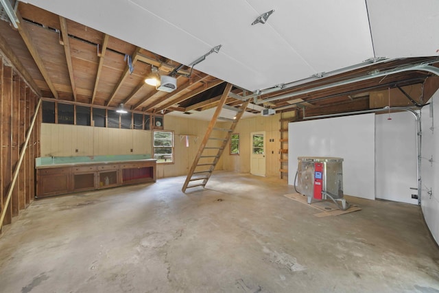 garage featuring wood walls and a garage door opener