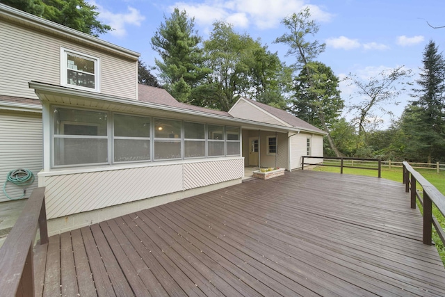 wooden deck with a sunroom