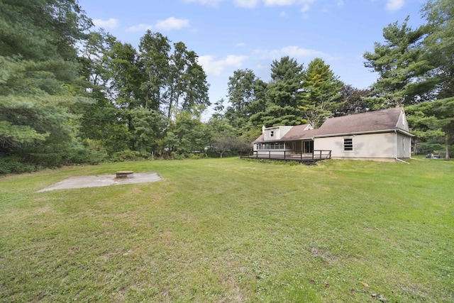 view of yard with an outdoor fire pit and a wooden deck