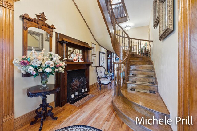 staircase with hardwood / wood-style flooring