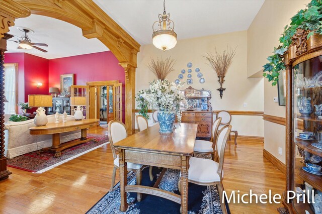 dining room featuring ornate columns, ceiling fan, and light hardwood / wood-style floors