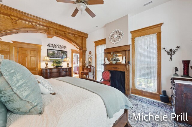 bedroom featuring ceiling fan and ornate columns