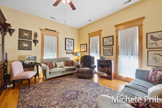 living room featuring light hardwood / wood-style flooring and ceiling fan