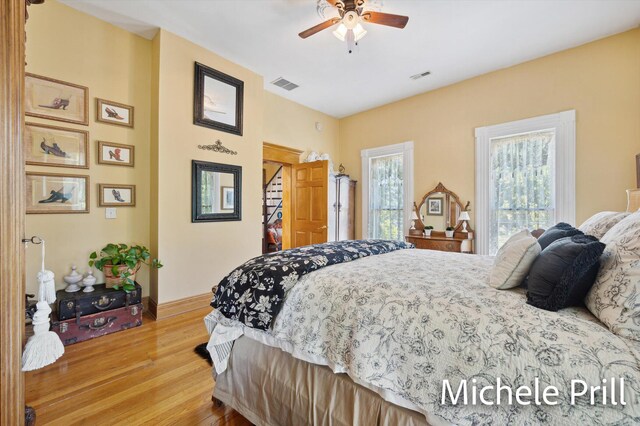 bedroom with ceiling fan and hardwood / wood-style flooring