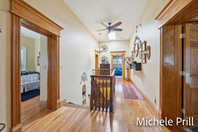 hallway with light wood-type flooring and plenty of natural light