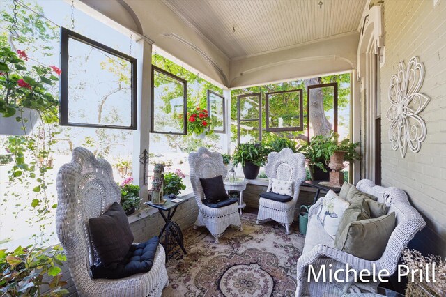 sunroom featuring wood ceiling and a wealth of natural light