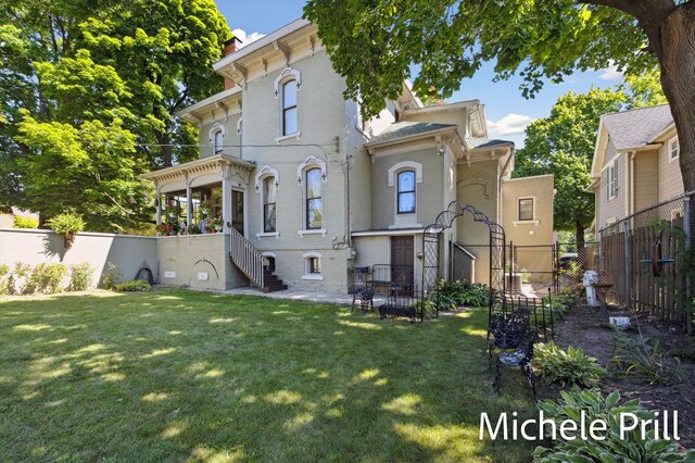 rear view of house with a lawn