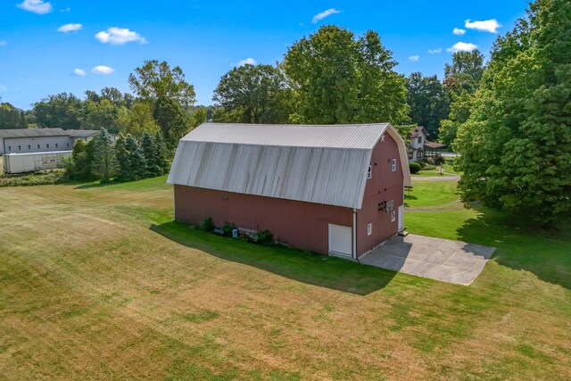 view of outbuilding with a yard