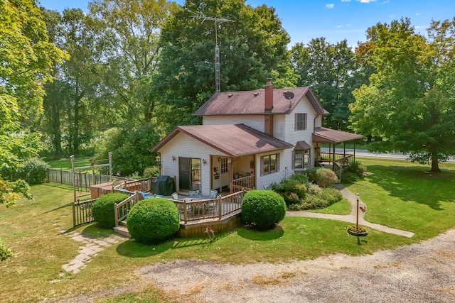 view of front of home with a front yard and a deck