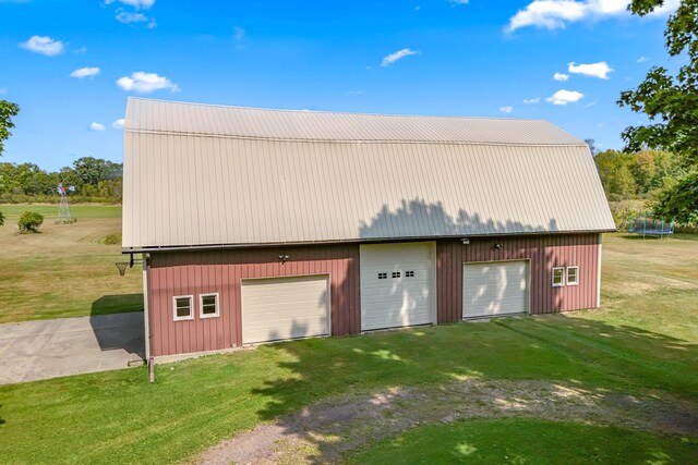 garage featuring a lawn