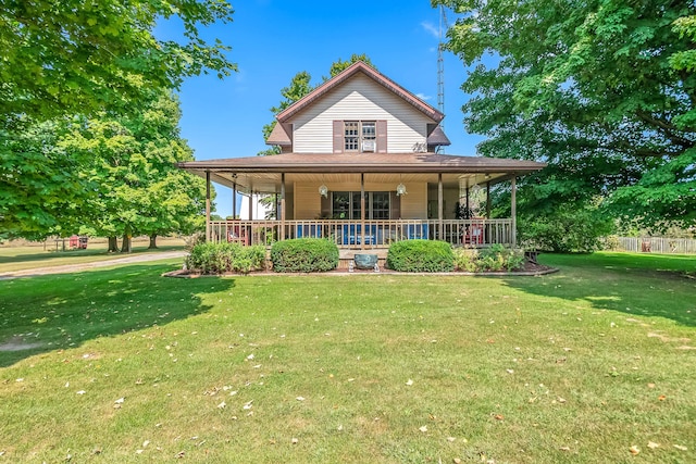 country-style home featuring covered porch and a front yard