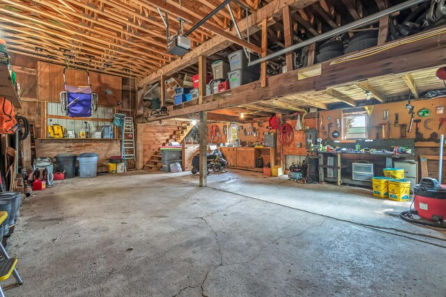 garage with a garage door opener and a workshop area