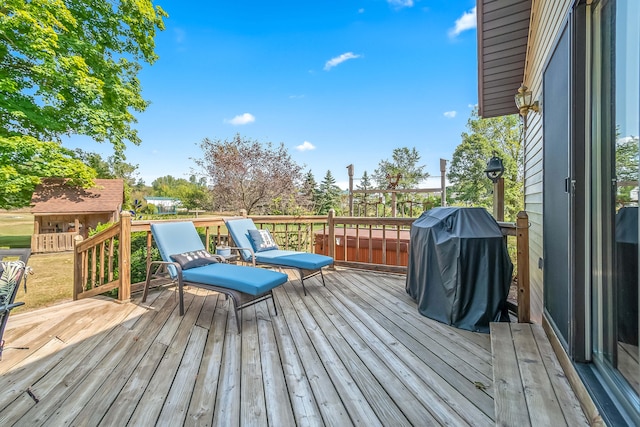 wooden deck featuring a grill