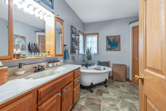 bathroom featuring vanity and a bath