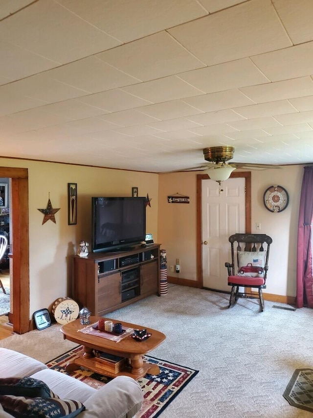 carpeted living room with ceiling fan