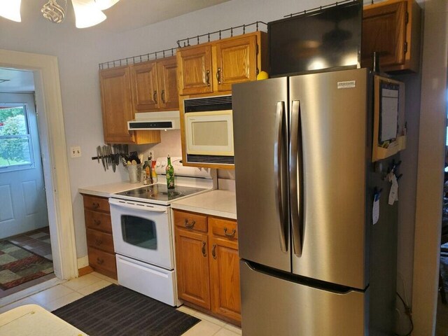 kitchen featuring white appliances and light tile patterned floors