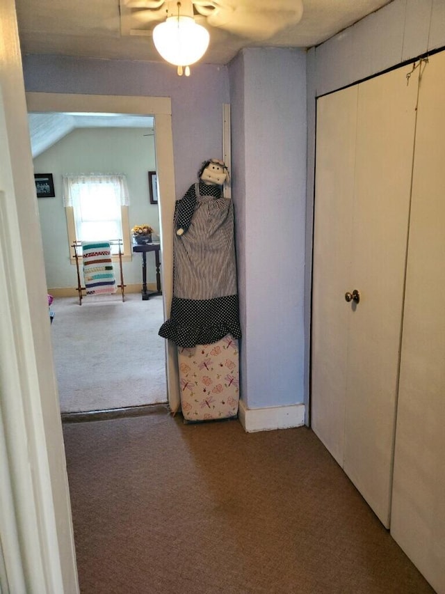 carpeted bedroom with vaulted ceiling, ceiling fan, and a closet