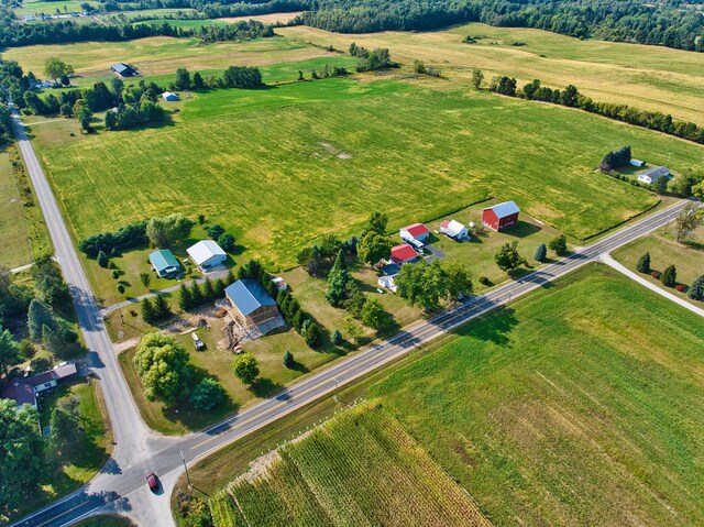 birds eye view of property with a rural view