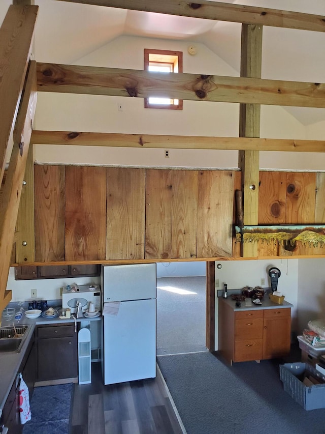 kitchen with white refrigerator and lofted ceiling