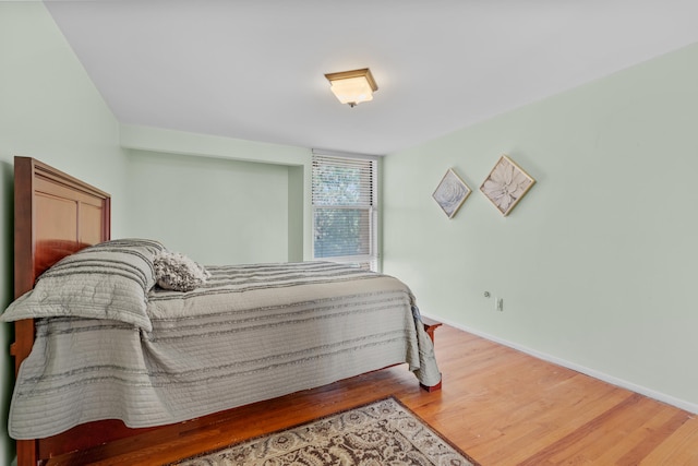 bedroom with hardwood / wood-style flooring