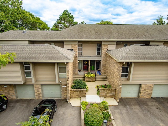 multi unit property featuring a garage