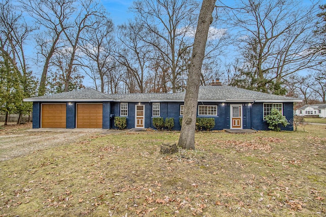 ranch-style home with a front yard and a garage