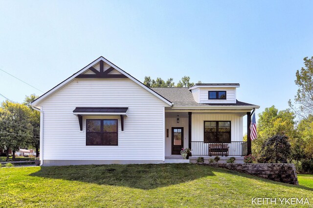 view of front of house with a porch and a front yard