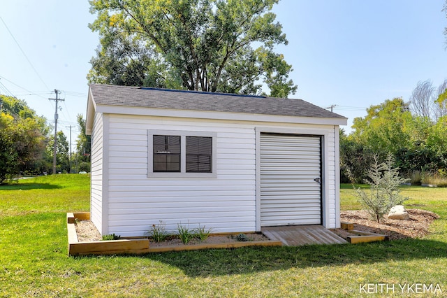 view of outbuilding with a lawn