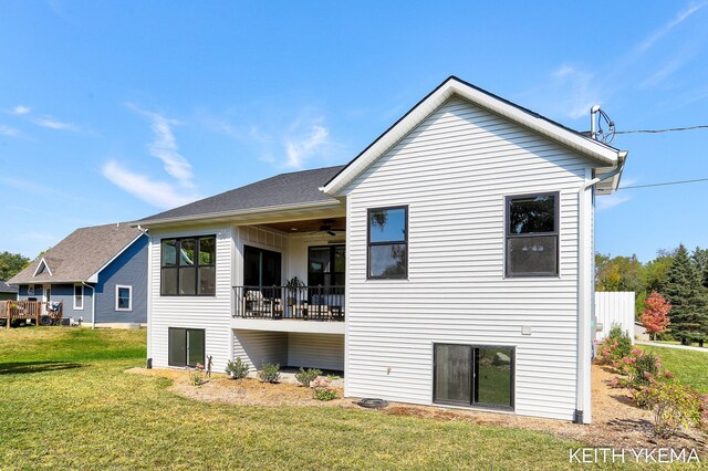 back of house featuring a yard and ceiling fan