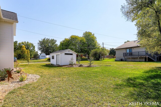 view of yard featuring a deck and a shed