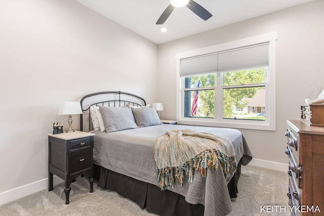 bedroom with light carpet and ceiling fan