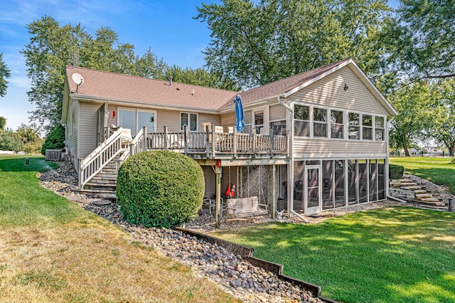 back of house with a lawn, a wooden deck, a sunroom, and central AC unit