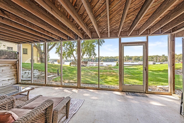 unfurnished sunroom featuring a water view