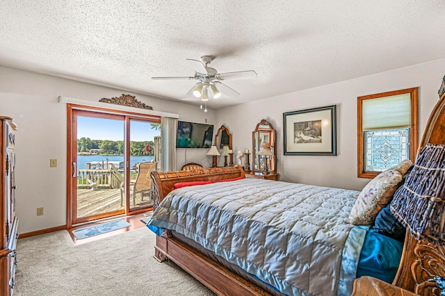 carpeted bedroom featuring ceiling fan, access to outside, and a textured ceiling