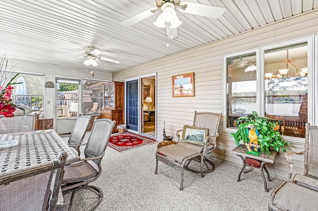 sunroom / solarium with wood ceiling and ceiling fan