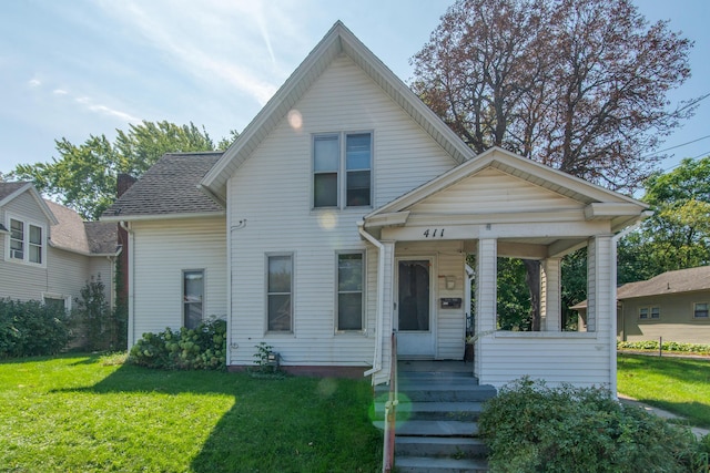 bungalow featuring a porch, a shingled roof, and a front yard