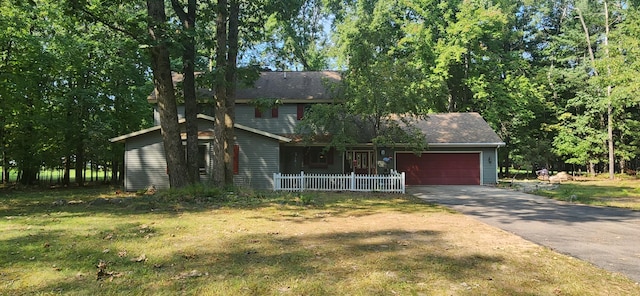 view of front of home featuring a garage and a front yard