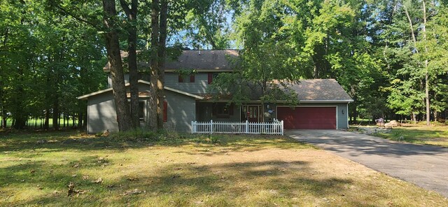 view of front of house with an attached garage, driveway, and a front lawn