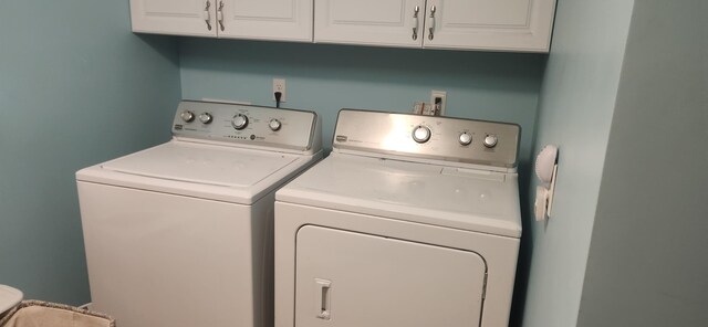 laundry room with cabinets and washer and clothes dryer