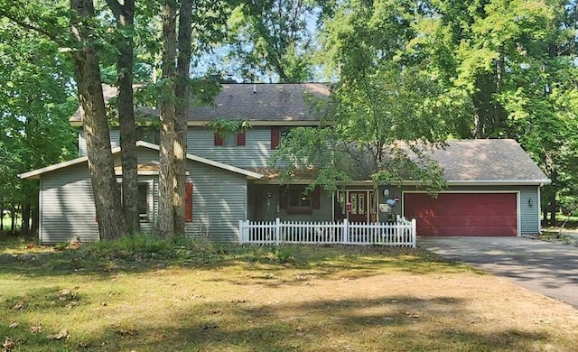 view of front of home with a garage and a front lawn