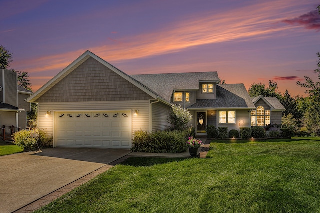 view of front of house with a yard and a garage