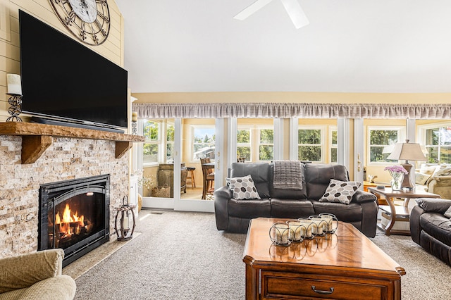 carpeted living room featuring a wealth of natural light and ceiling fan