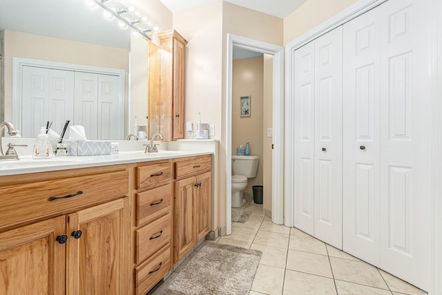 bathroom featuring tile patterned flooring, vanity, and toilet