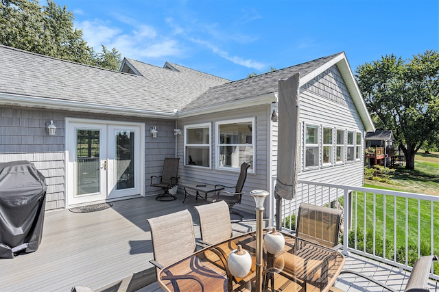 wooden deck featuring a yard and area for grilling