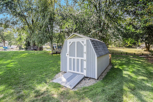 view of outdoor structure featuring a lawn